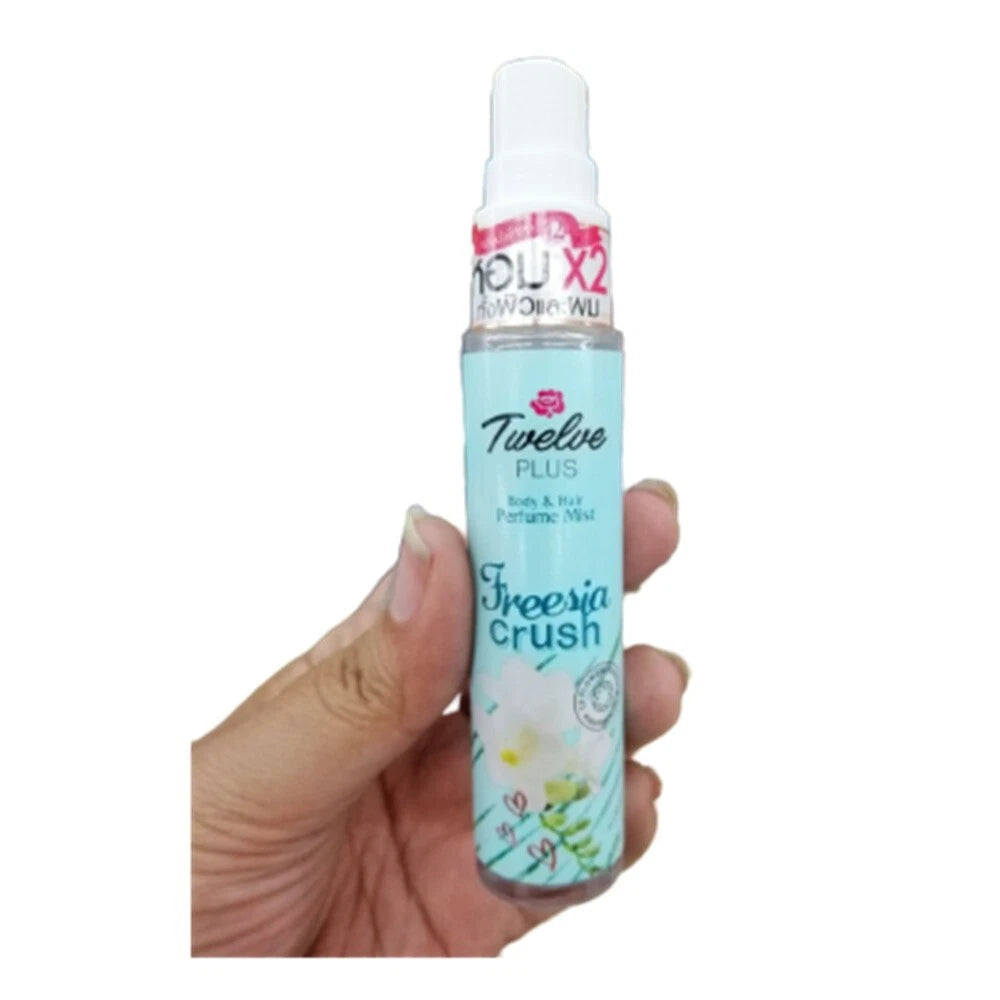 Twelve Plus Freesia Crush Mist body and hair perfume 25ml bottle held in hand