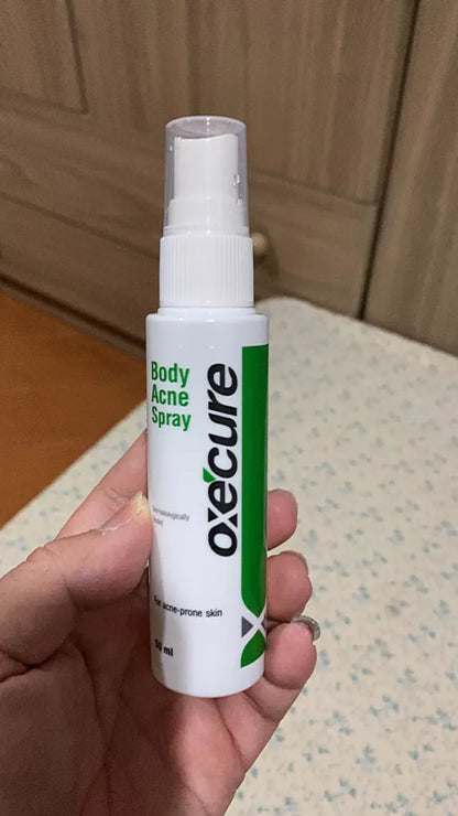 Oxe Cure Body Acne Spray bottle held in hand for daily acne care routine