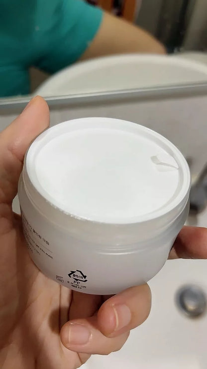 Hand showing inside texture of COSRX Advanced Snail Mucin 92 All in One Cream jar