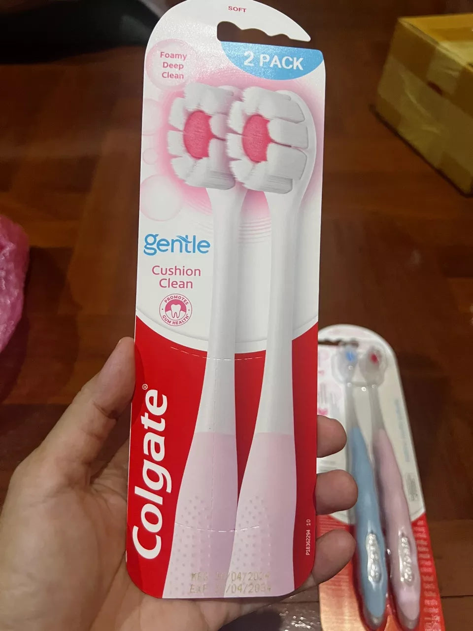 Colgate Cushion Clean Toothbrush packaged pair close up with Colgate logo and soft bristle tips