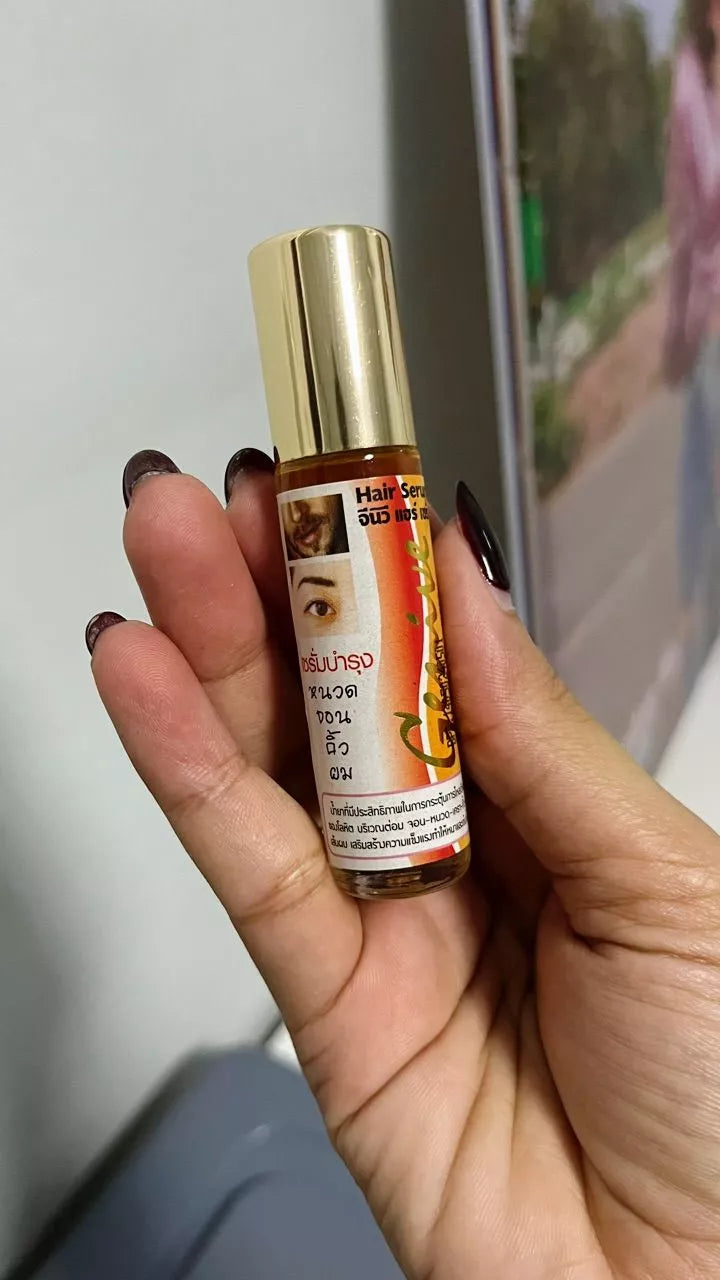 Genive Hair Growth Serum handheld bottle close up