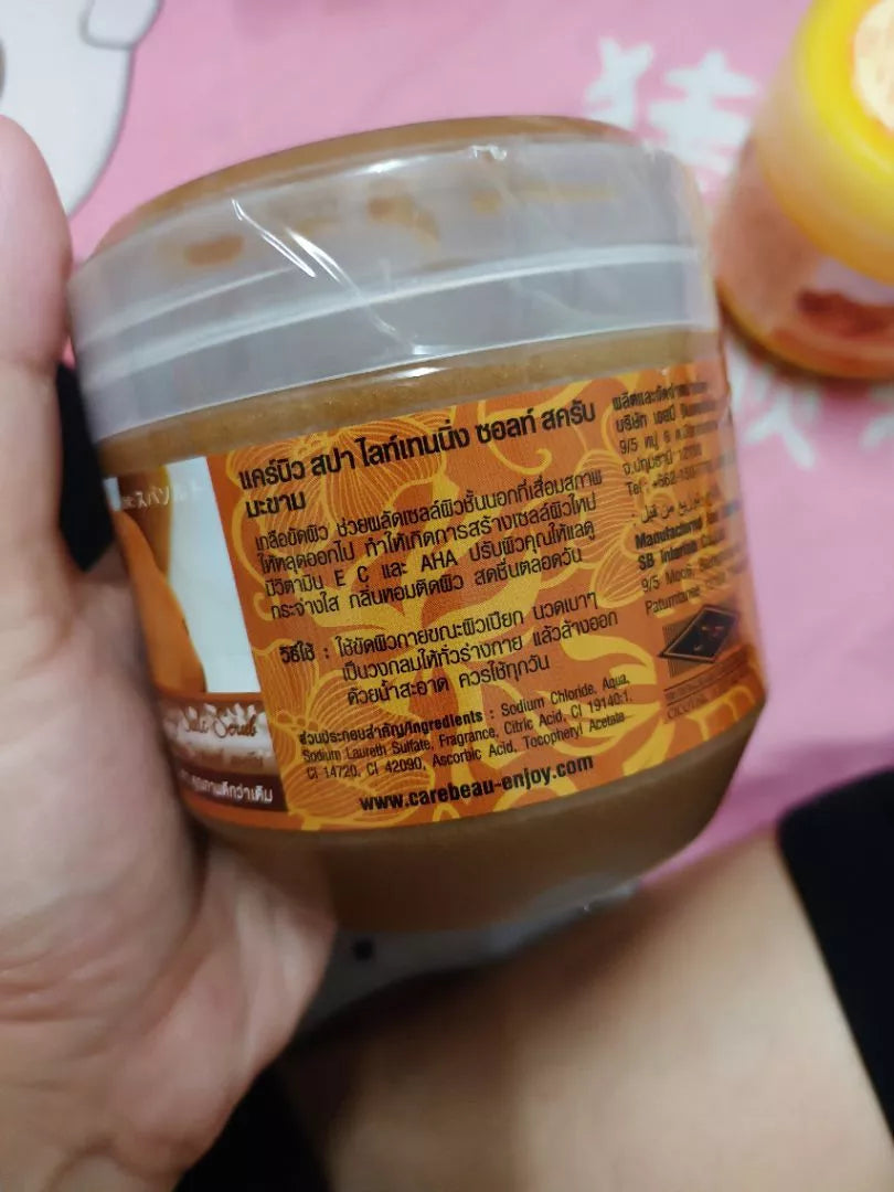 Carebeau Tamarind Salt spa scrub jar held in hand front label