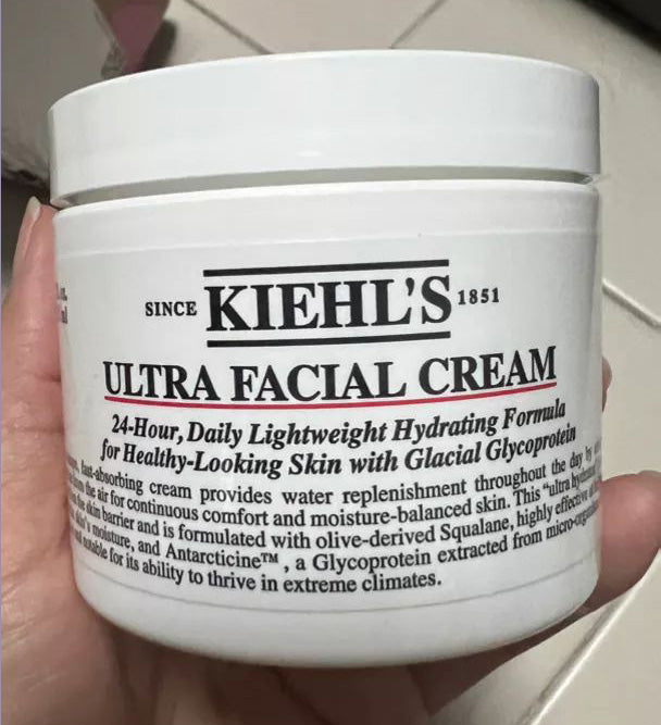 Kiehl's Ultra Facial Cream front jar held in hand close-up