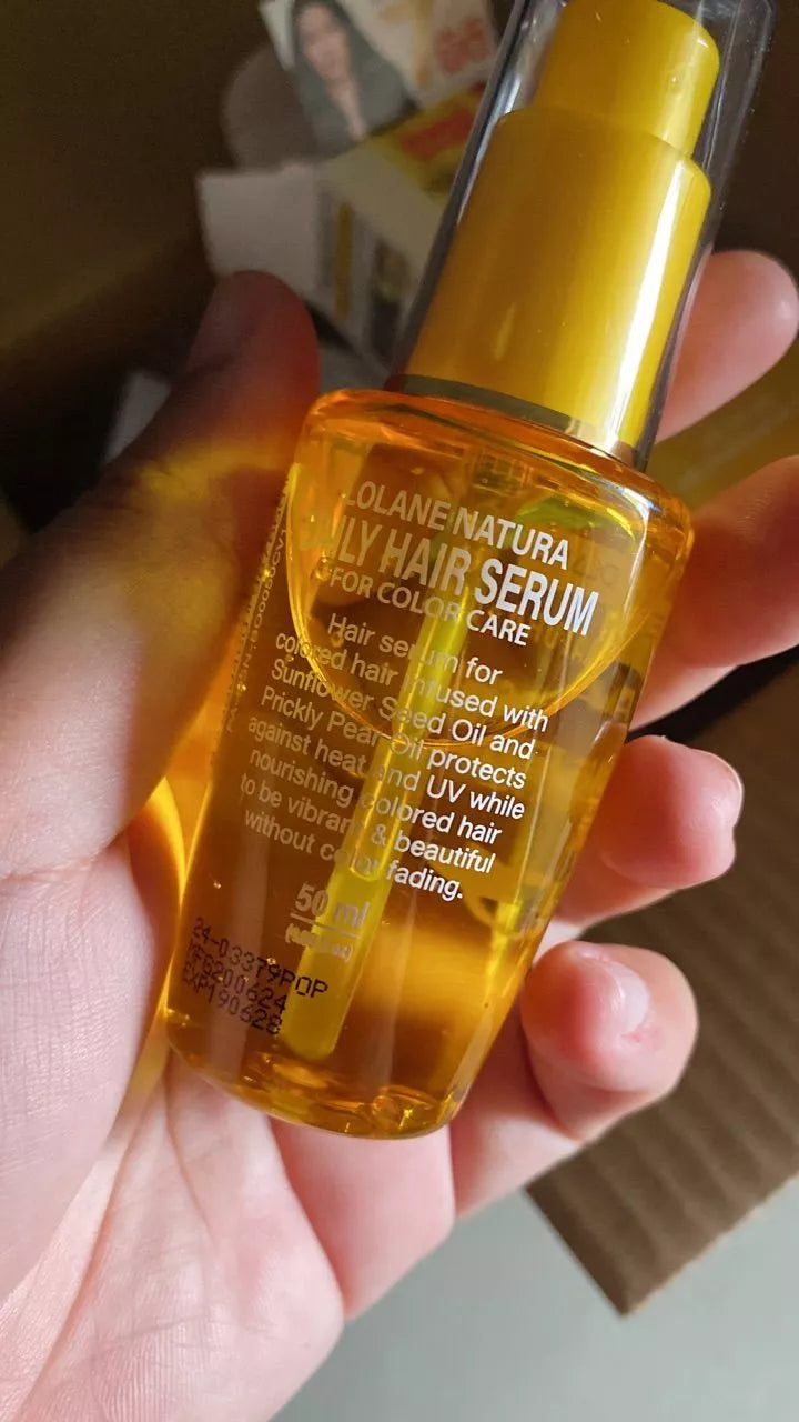 Lolane Natura Color Hair Serum Daily Magic In One Sunflower Oil 50ml bottle held in hand, designed for color care.