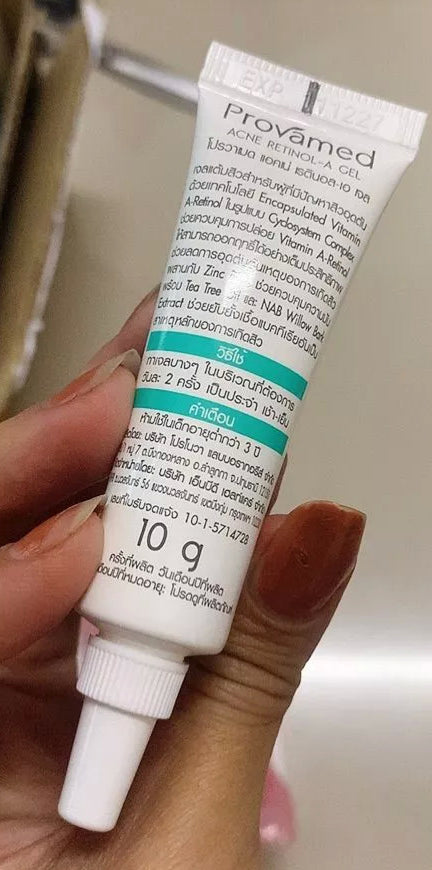Hand holding Provamed Retinol-A Acne Gel tube close-up
