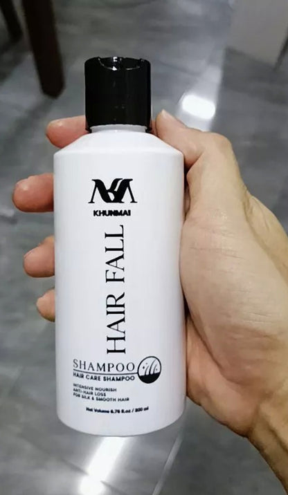 KHUNMAI Hair Fall Shampoo bottle backside held in hand