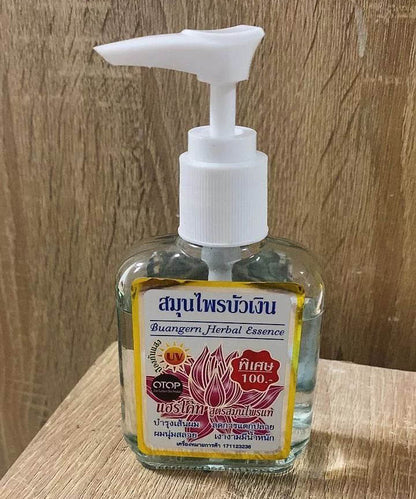 Buangern Hair Essence Herbal 85ml bottle front view with pump on wood background