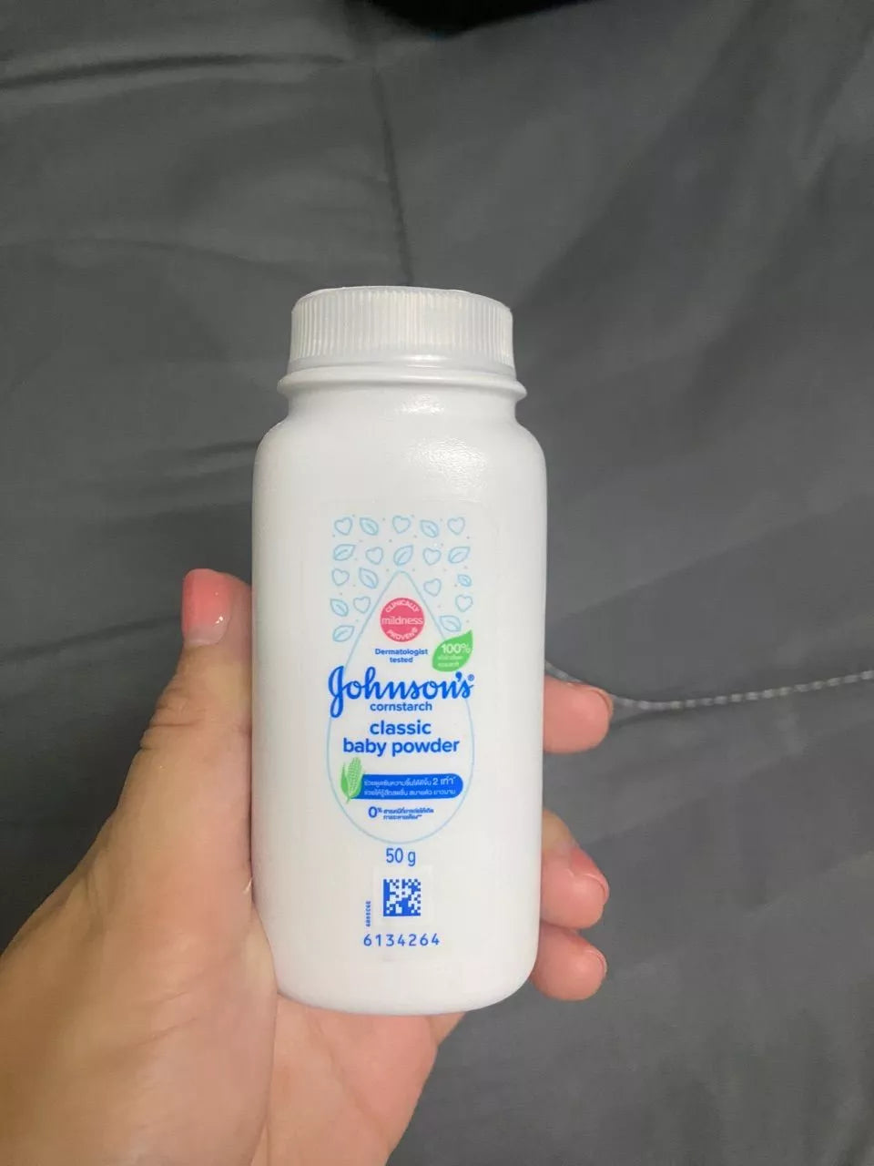  Close-up of Johnson’s Baby Powder Classic Scent 50g held upright in hand