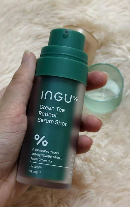 Close-up of INGU Retinol Serum Shot bottle label while held in hand