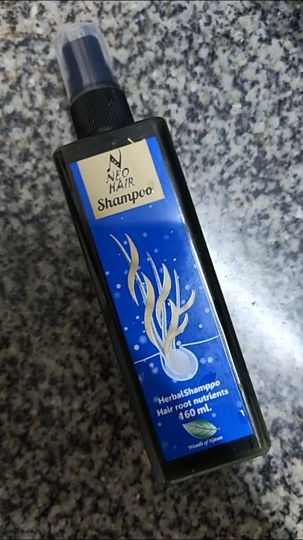 Neo Hair Shampoo spray bottle lying on table for hair loss care