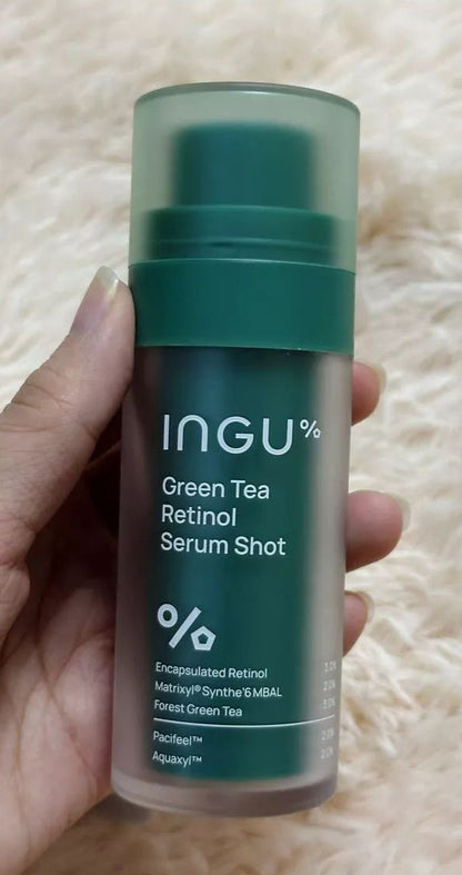 Close-up hand photo featuring INGU Retinol Serum Shot bottle with clear label and design