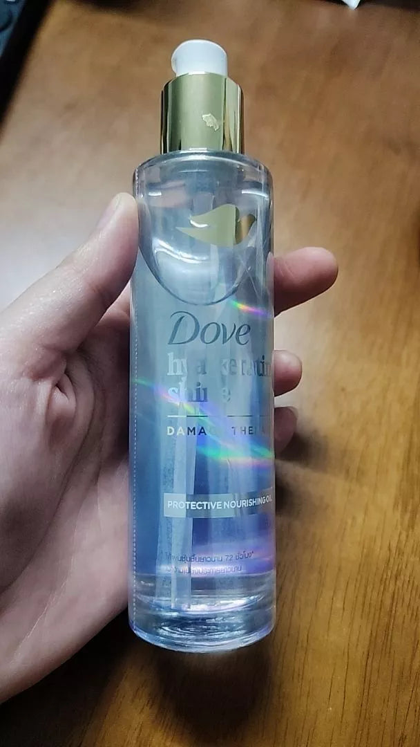 Dove Hya Keratin Oil real product bottle display on surface