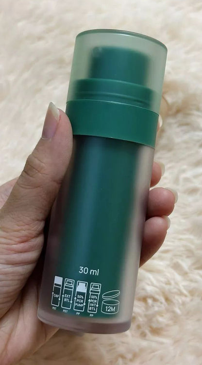 Hand holding INGU Retinol Serum Shot bottle showing green packaging design