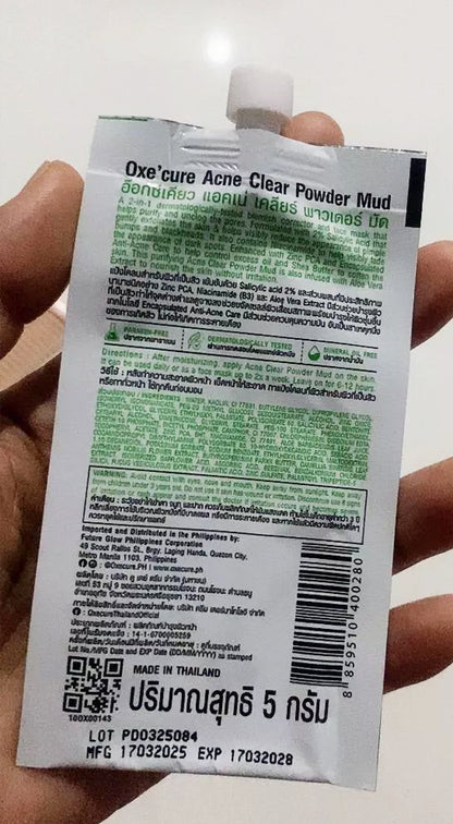 Oxe Cure Acne Clear Powder Mud sachet held in hand showing back label details