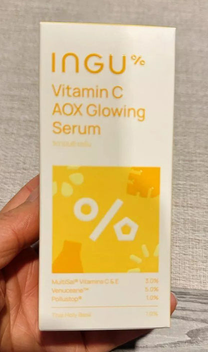 Closeup of INGU Vitamin C AOX serum bottle with product label clearly visible