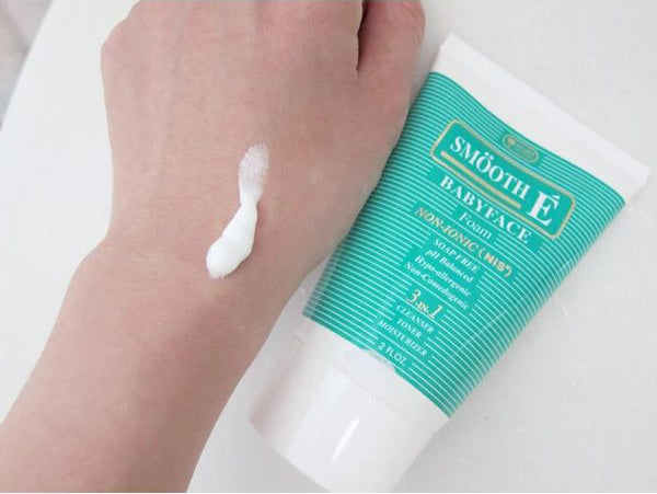 Smooth E Babyface Foam facial cleanser tube held in hand for daily skincare use
