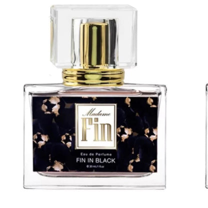 Close up of Madame Fin Fin in Black Eau de Parfum spray bottle with black floral label.