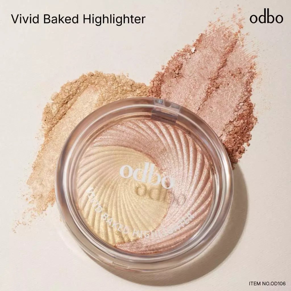 Odbo Vivid Baked Highlighter in a clear compact showcasing golden and rosy shimmer hues.
