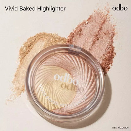 Odbo Vivid Baked Highlighter in a clear compact showcasing golden and rosy shimmer hues.