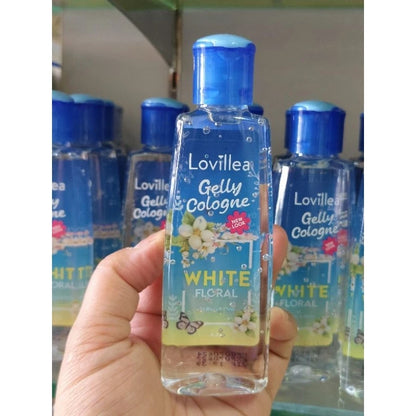 Lovillea White Floral Cologne multiple bottles display with hand holding one bottle for size reference