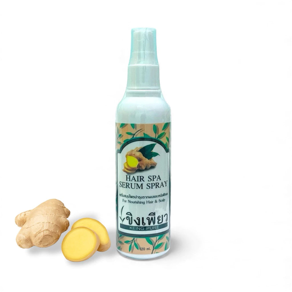Keing Pure Hair Serum spray bottle next to fresh ginger root slices.