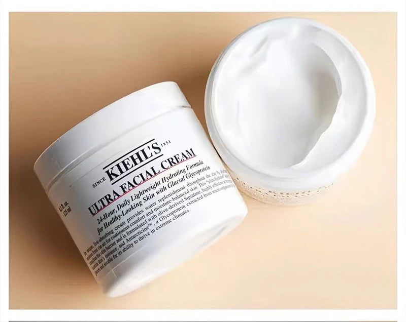 Kiehl's Ultra Facial Cream open jar showing creamy texture on a wooden surface