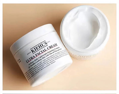 Kiehl's Ultra Facial Cream open jar showing creamy texture on a wooden surface