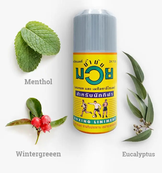 Namman Muay Liniment Oil with menthol and herbal leaves illustrating natural active ingredients for muscle relief and sports massage