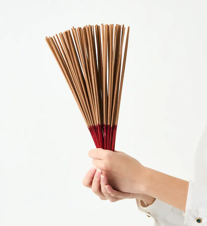 Noppamas Incense Sticks bundle held in hand showing bamboo sticks