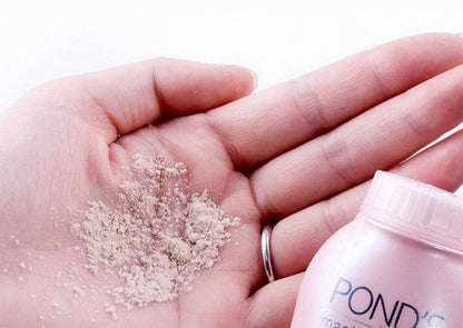 POND'S Perfect Radiance BB Powder in hand, showcasing translucent loose powder for natural, radiant skin.